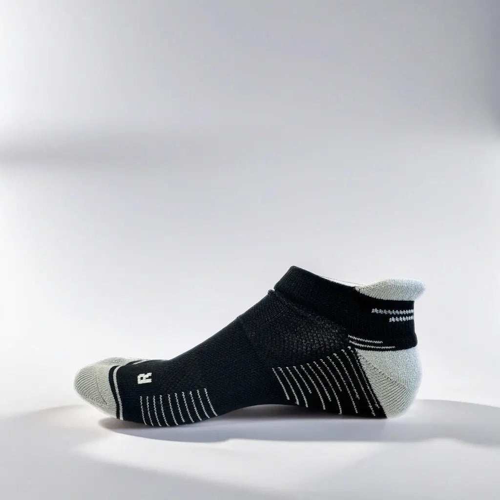 Low cut black and grey running socks with arch support and ventilation designed for comfort and stability during runs